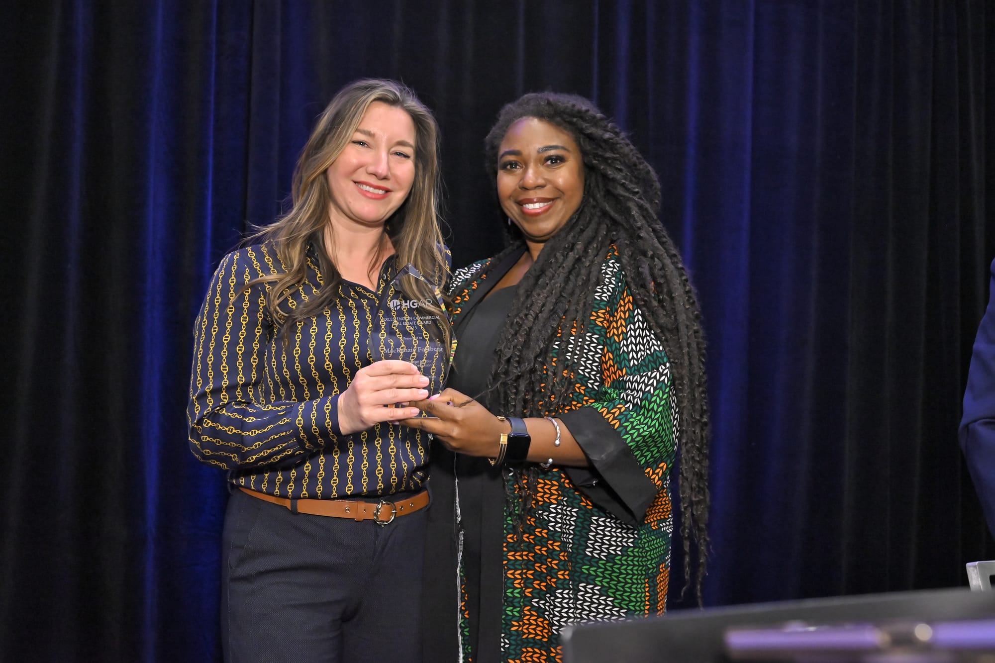 MacKenzie Forsberg, left, winner of HGAR’s “Excellence in Commercial Real Estate Award,” and Crystal Hawkins-Syska, HGAR Recognition Committee Chair.