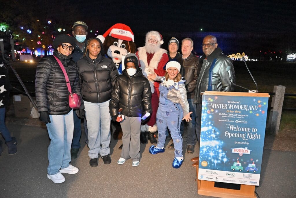 From left, (front row) HGAR’s Valerie Williams (mom); Brianna Gilzene (sister); daughter Iyanna Gilzene and Snowball the Elf; back row: Dwight Gilzene (dad); Robbie Dog; Santa Claus; Westchester Parks Foundation Chairperson Seth Mandelbaum; Dr. Matthew Pinto Section Chief, Pediatric Intensive Care Unit at the Maria Fareri Children's Hospital, a member of the Westchester Medical Center Health Network and Westchester Deputy County Executive Ken Jenkins. PHOTO BY JOHN VECCHIOLLA