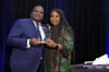 Anthony Domathoti receiving his 2023 Realtor of the Year award from Recognition Committee Co-Chair Crystal Hawkins-Syska.